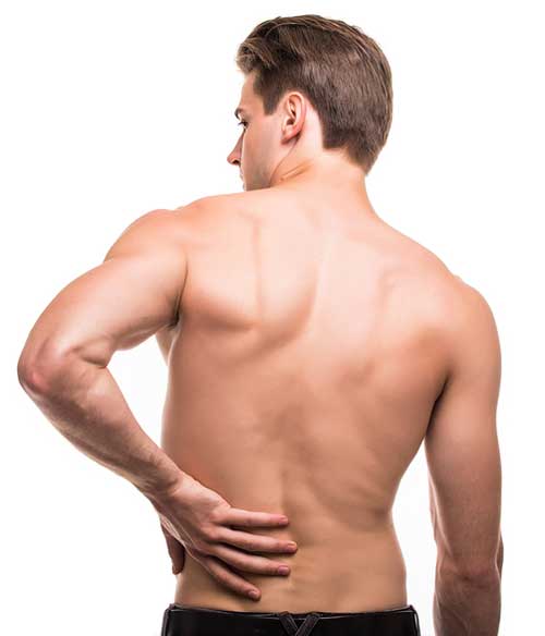 man rubbing his painful back